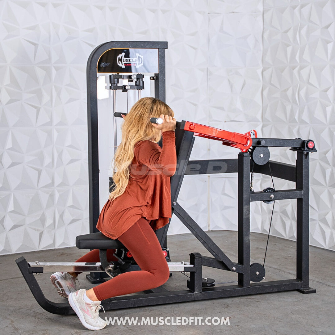 Woman exercising on a Classic V2 Selectorized Multi-Press Chest & Shoulder Press machine with a textured white wall background