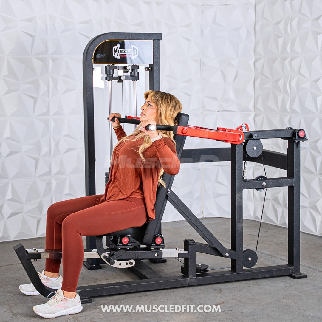 Woman using a Classic V2 Selectorized Multi-Press Chest & Shoulder Press in a gym setting with a textured white wall background.