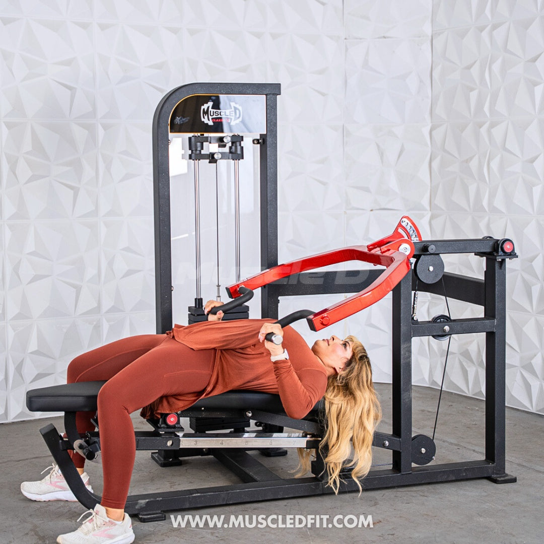 Woman exercising on a Classic V2 Selectorized Multi-Press Chest & Shoulder Press machine with a white textured wall background
