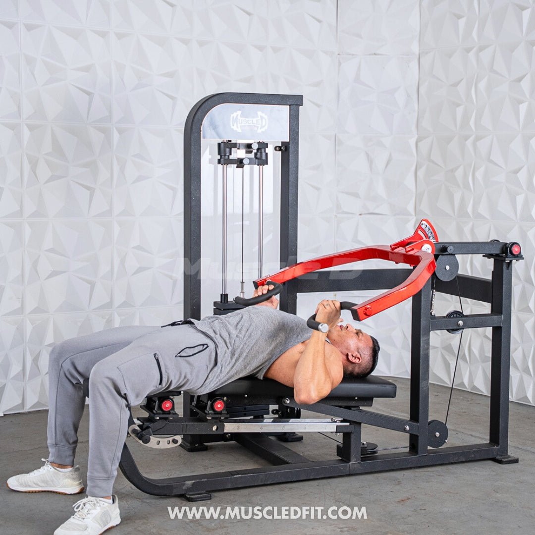Person using a Classic V2 Selectorized Multi-Press Chest & Shoulder Press in a home setting with a light gray textured wall background.