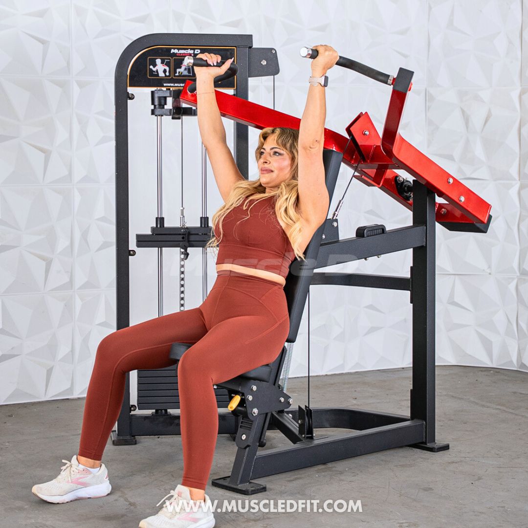 Woman exercising on a Classic V2 Shoulder Press machine in a gym setting