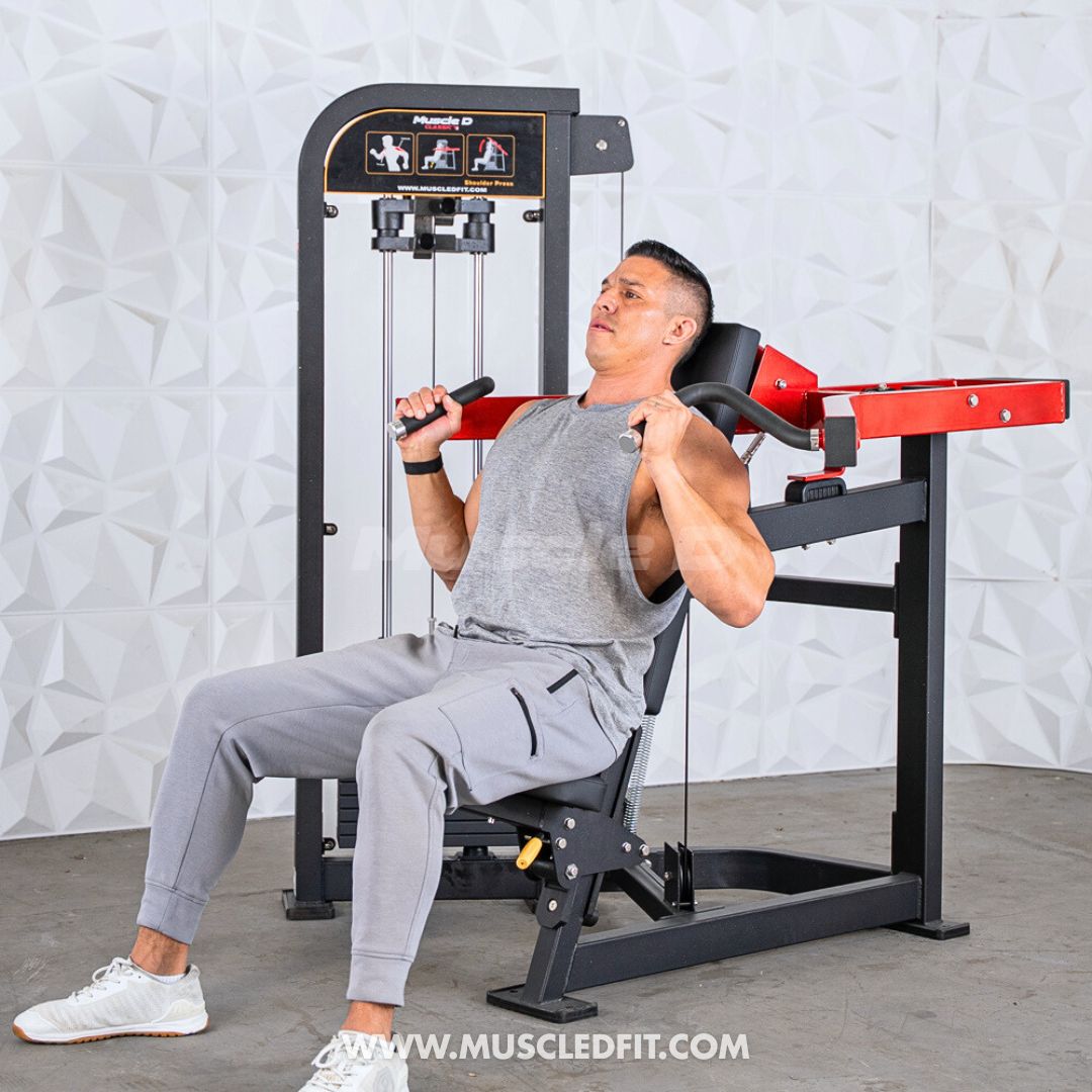 Man exercising on a Classic V2 Shoulder Press  machine in a gym setting