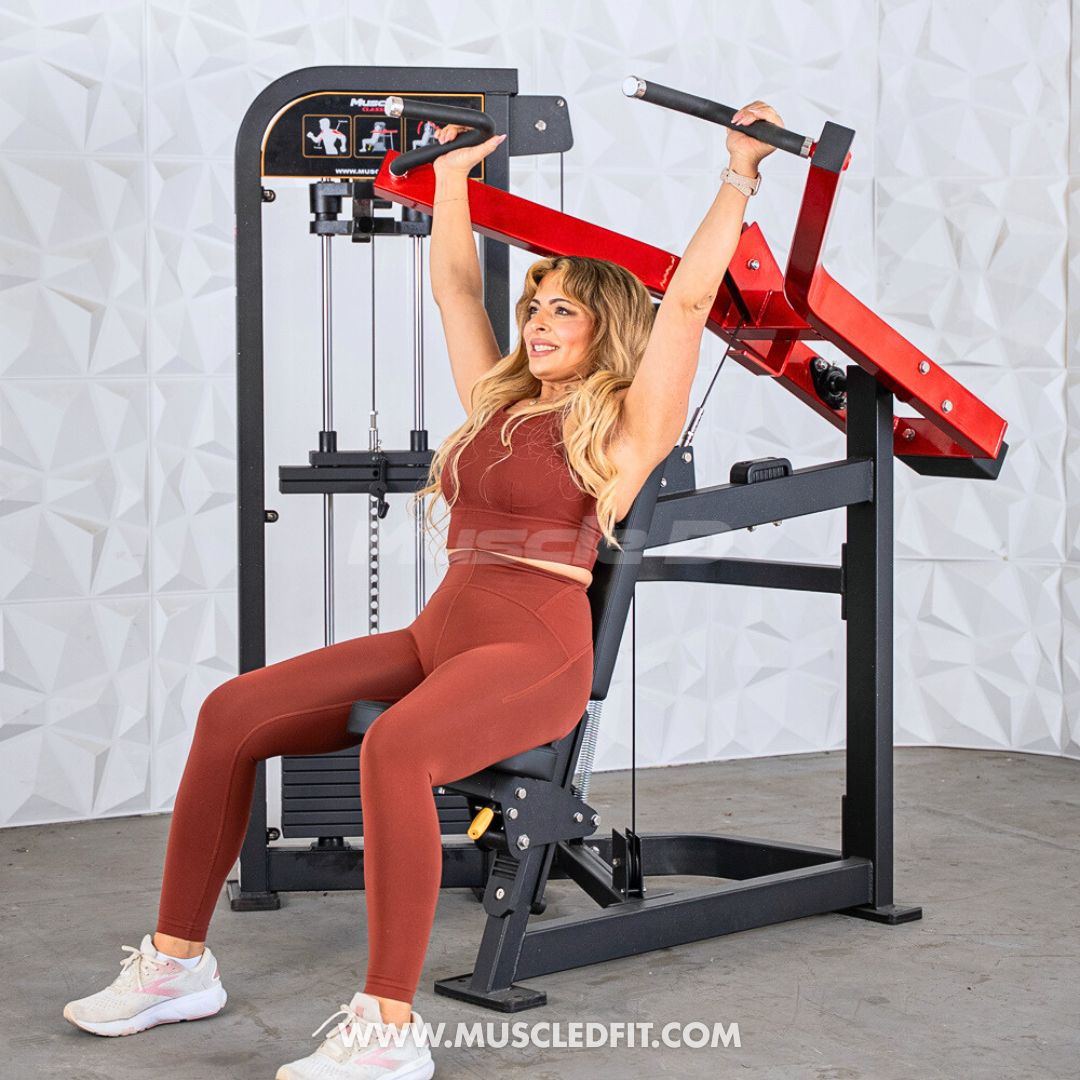Woman exercising on a Classic V2 Shoulder Press machine in a gym setting