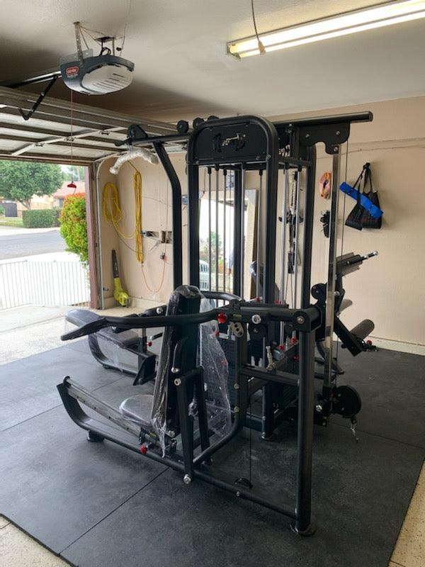 4 Stack Megatron Compact Multi-Gym in a garage setting by Muscle D Fitness.