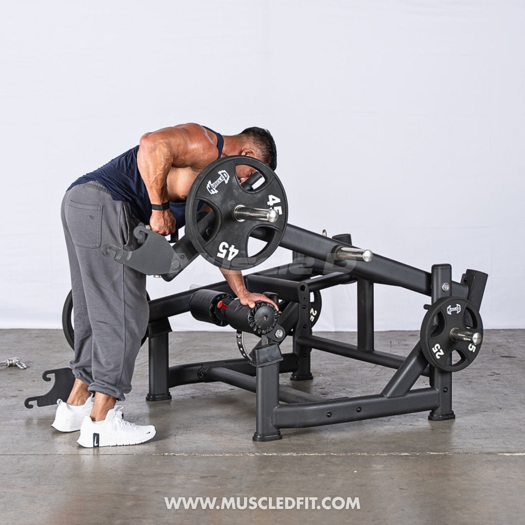 Person using an Excel Multi Function Deadlift Shrug Station machine in a gym setting by Muscle D Fitness.