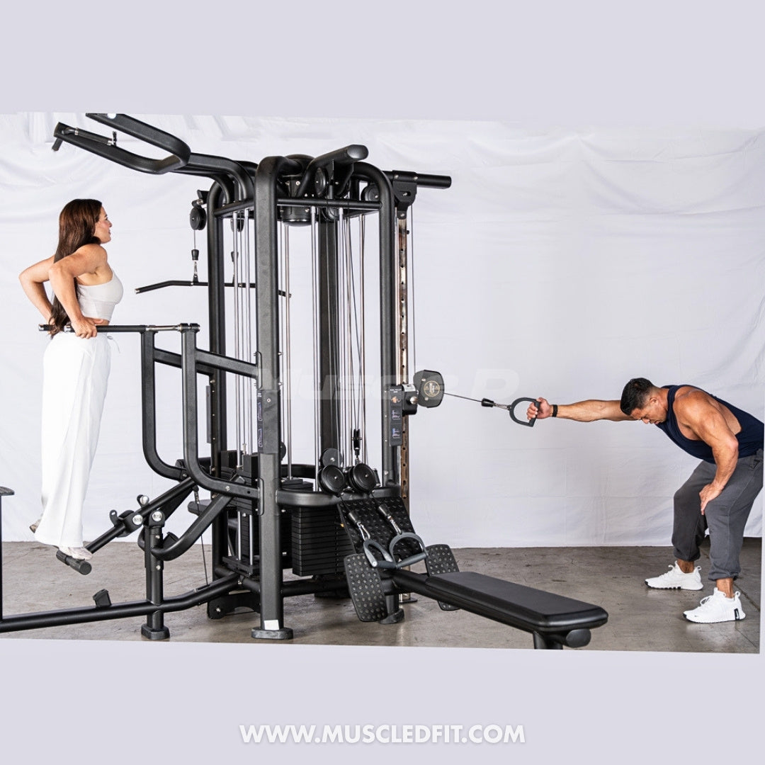 Person using a 4-Stack Jungle Gym w/ Assisted Chin / Dip machine with another person training, on a white background.