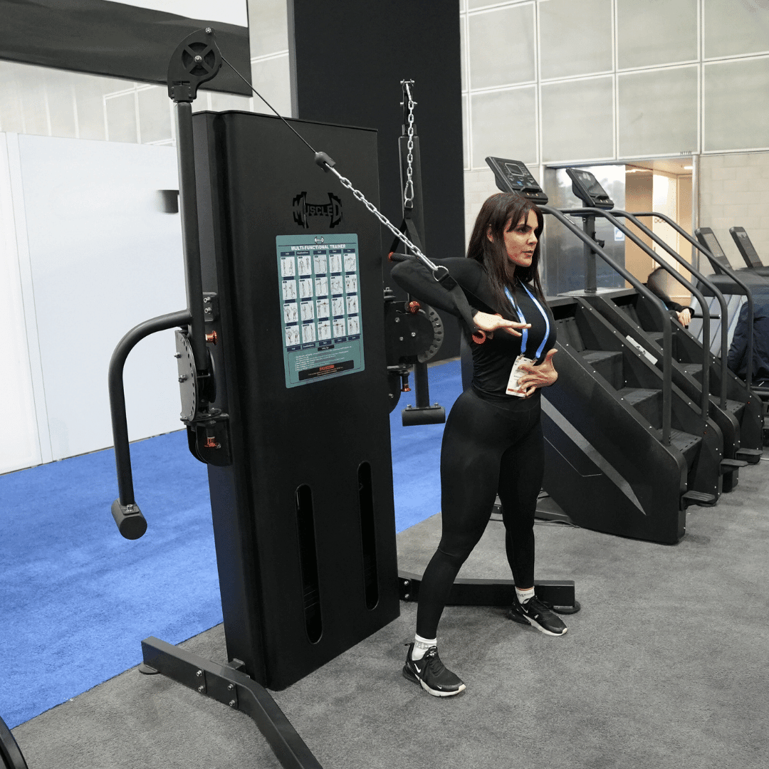 Woman training on a Megatron Multi-Functional Trainer in a gym setting by Muscle D Fitness