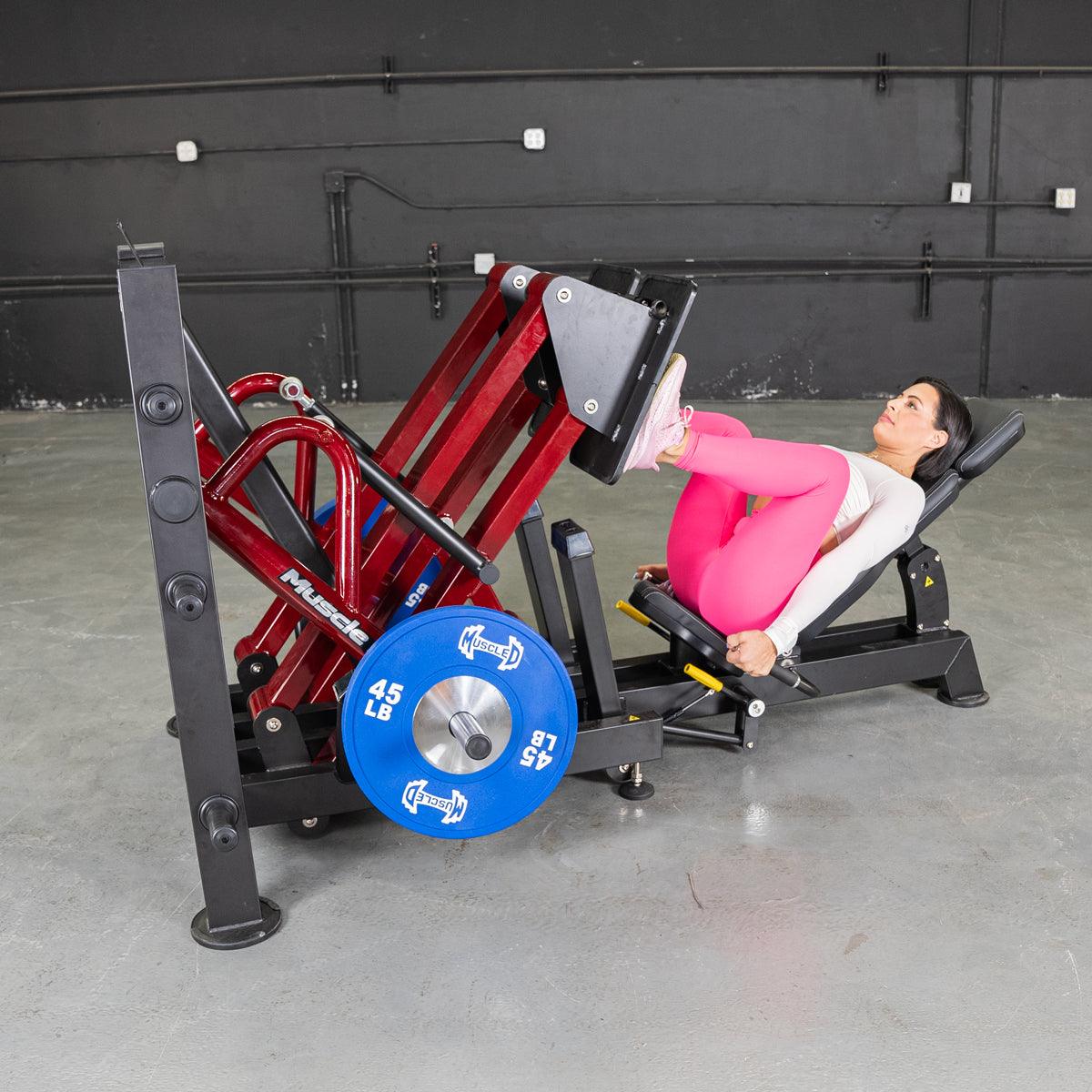 Woman training on a Power Leverage V2 45-Degree Iso Lateral Leg Press in a gym setting by Muscle D Fitness.