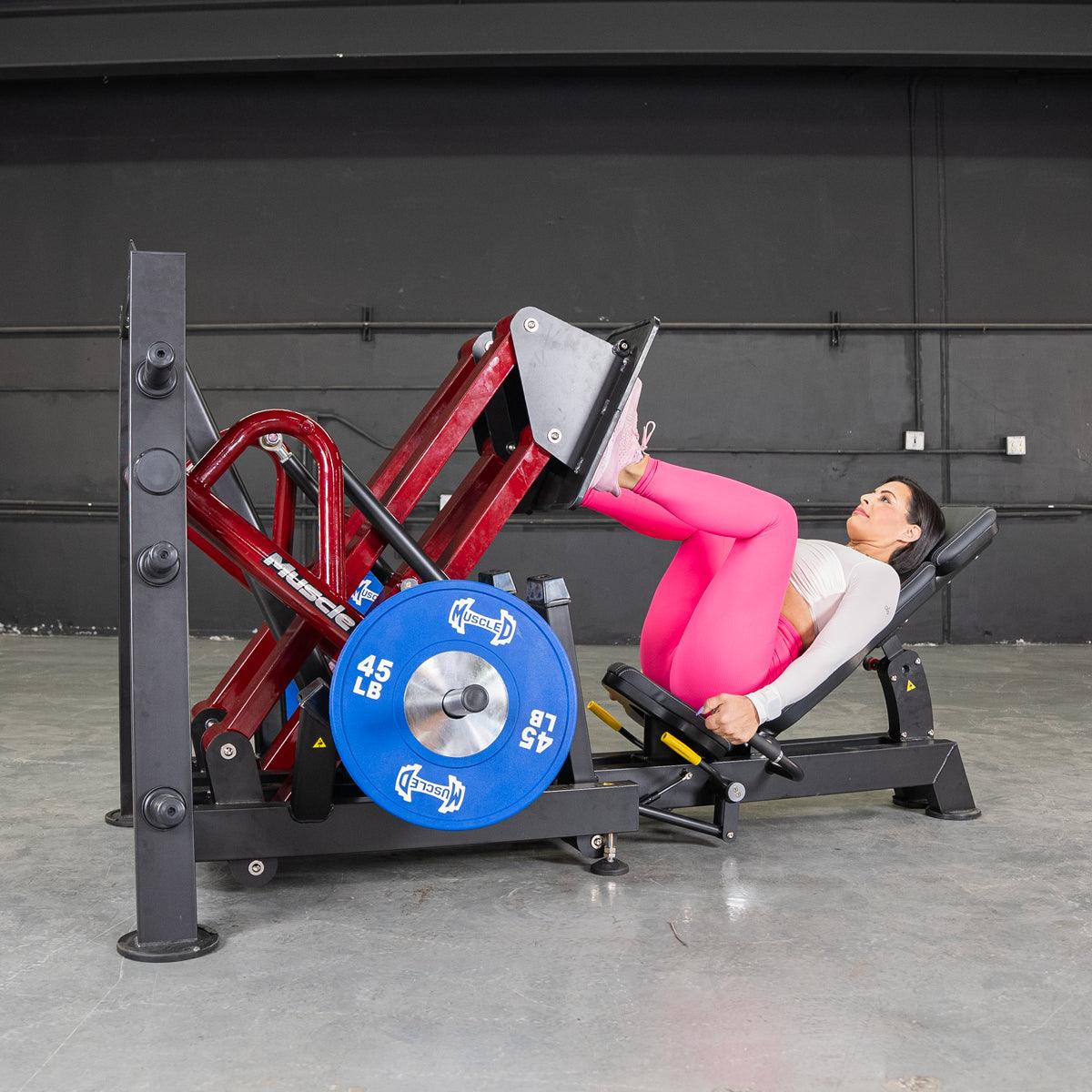 Woman uising a Power Leverage V2 45 Degree Iso Lateral Leg Press in a gym environment by Muscle D FItness.