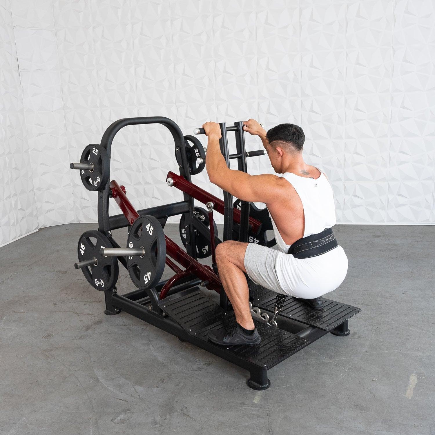 Man using a Pro Strength Belt Squat by Muscle D Fitness in a Gym Setting.