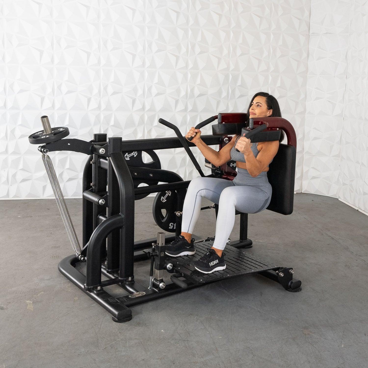 Woman using a Pro Strength Drop Squat by Muscle D Fitness in a gym setting.