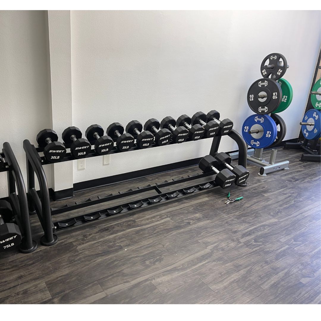 black dumbbell set five to a hundred pounds sets includes twenty pairs of dumbbells on two ten pairs dumbbell rack that is sold separately