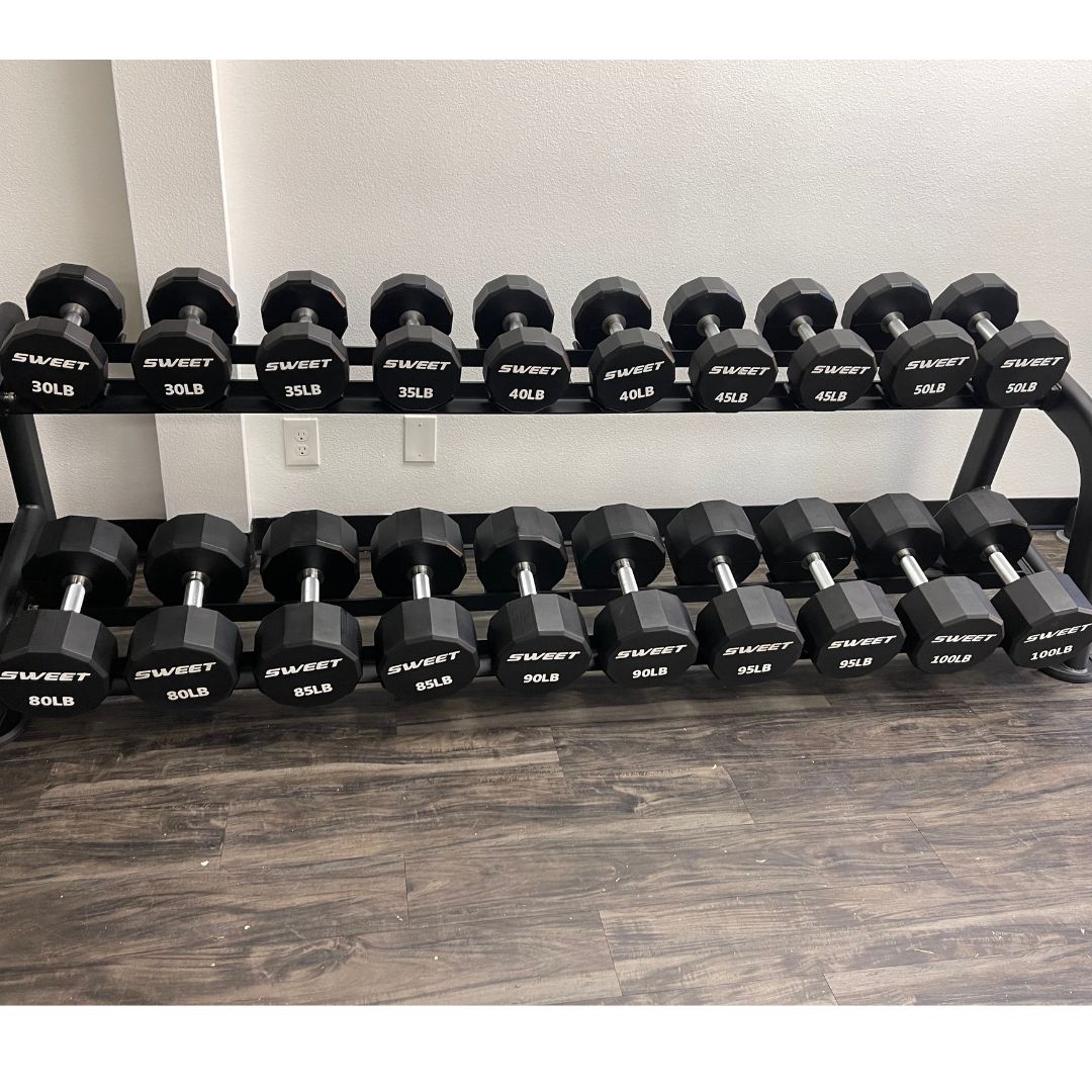 black dumbbell set five to a hundred pounds sets includes twenty pairs of dumbbells on two ten pairs dumbbell rack that is sold separately