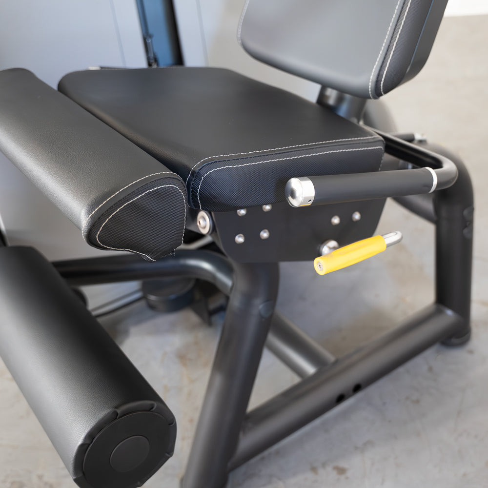 commercial grade black and white selectorized leg extension machine detail