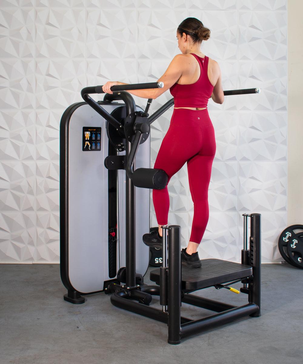 Woman using the Vogue Multi-Hip in a gym setting by Msucle D Fitness